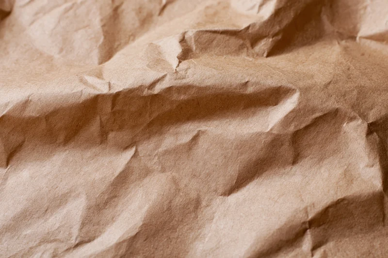 Crumpled brown kraft paper filling the frame as a textured surface