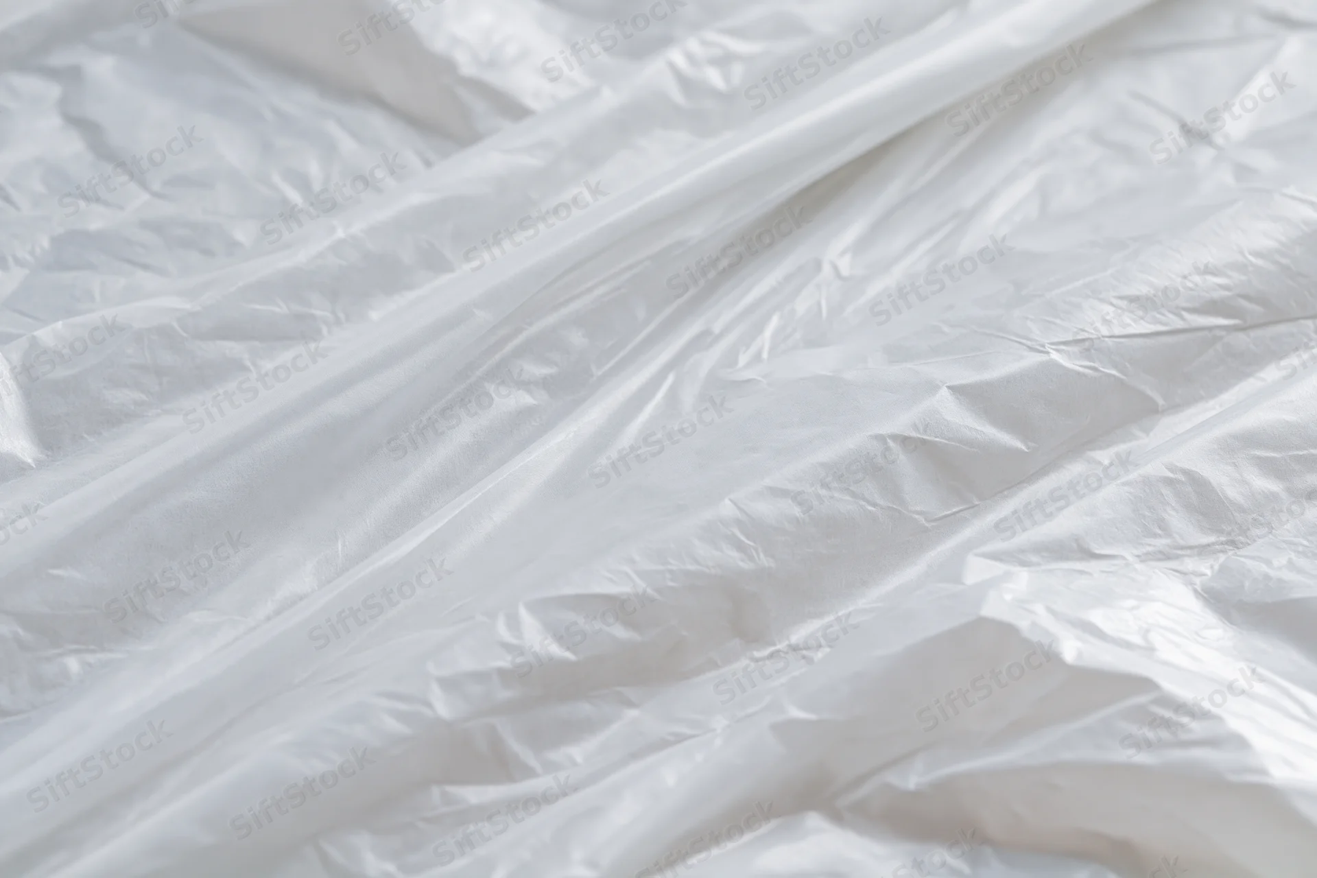 Crumpled transparent plastic wrap filling the frame as a textured surface