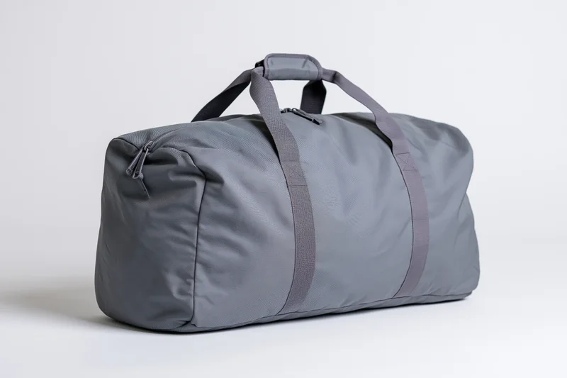 Gray nylon duffel bag standing upright on white background