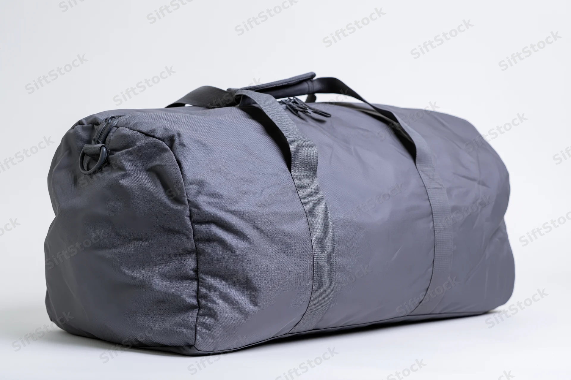 Grey nylon duffel bag with straps and zipper closure on white background