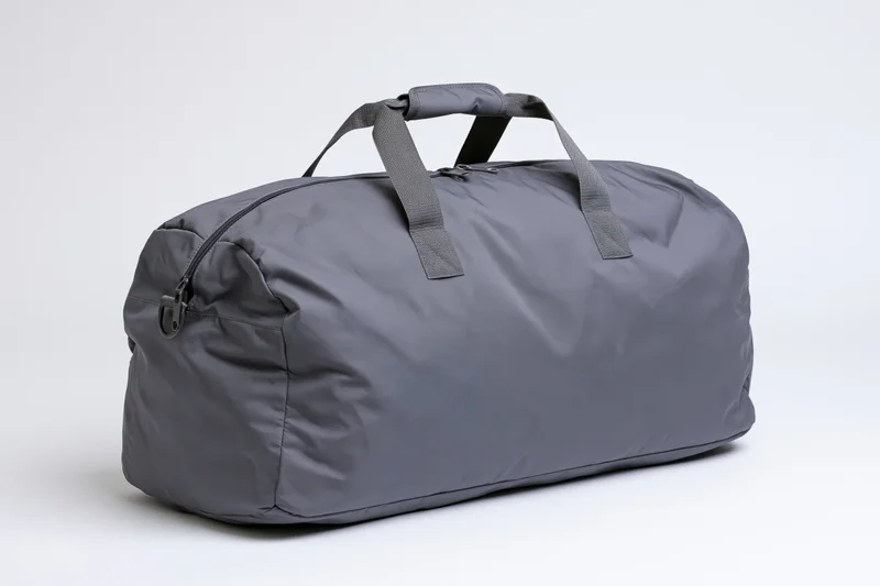 Gray nylon duffel bag standing upright on white background