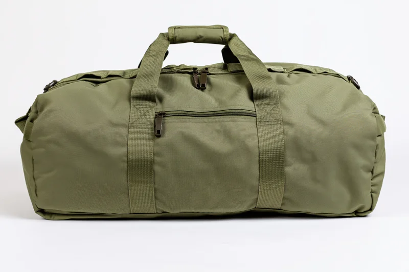 Olive drab military duffel bag lying flat on white background
