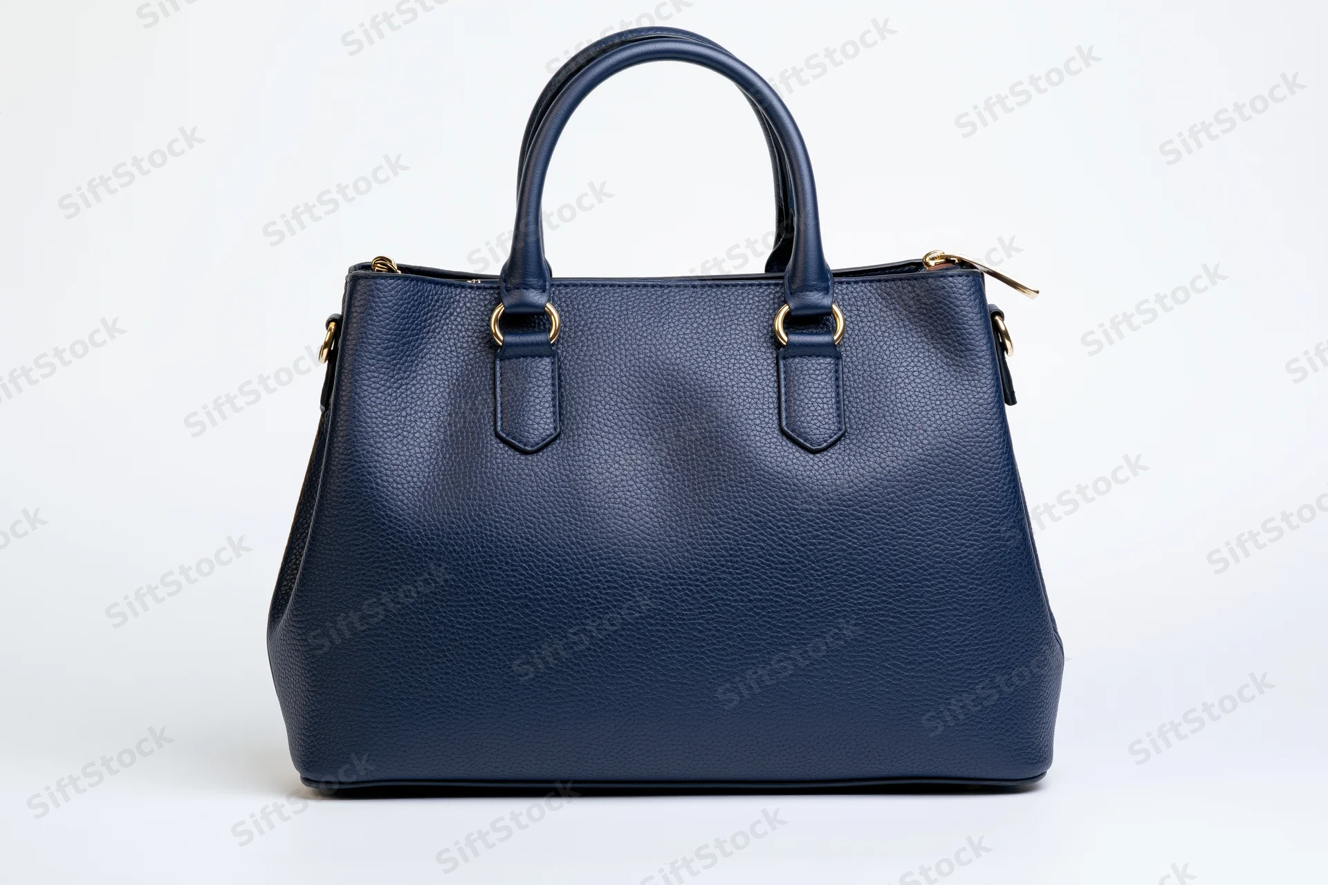Navy blue pebbled leather tote handbag photographed straight-on against white background