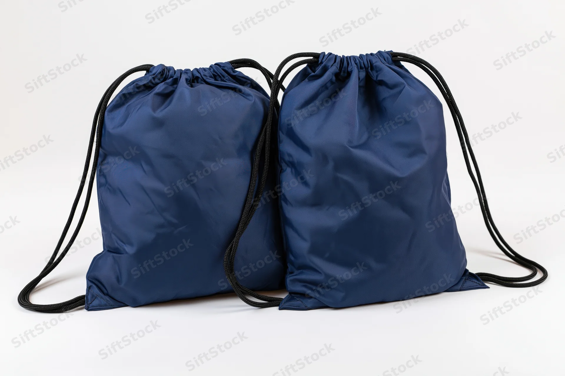 Two navy blue drawstring backpacks side by side on white background