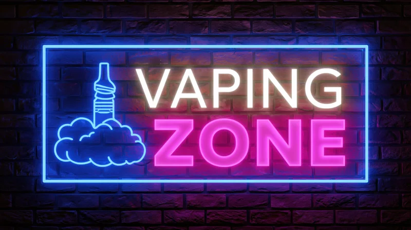Neon sign reading vaping zone mounted on a dark brick wall