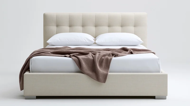 Modern upholstered queen bed with tufted headboard and white bedding on plain background