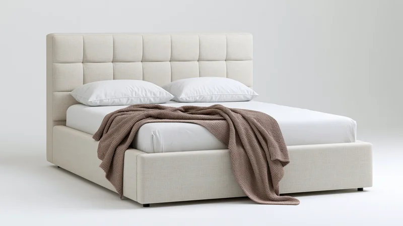 Modern upholstered queen bed with tufted grid-pattern headboard and white bedding on plain background