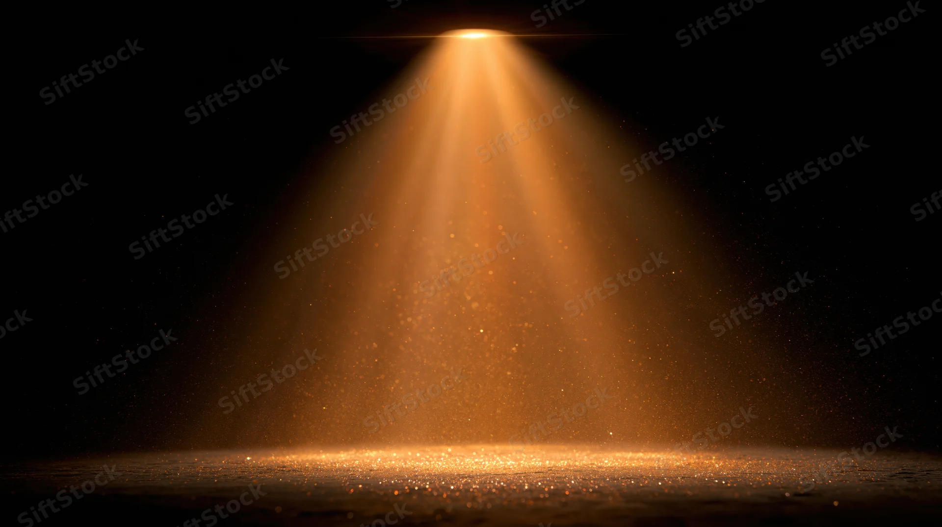 Golden spotlight beam shining downward on a dark stage floor