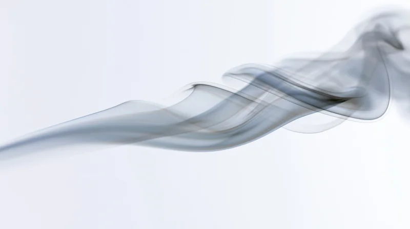 A wisp of gray smoke drifting diagonally across a pure white background
