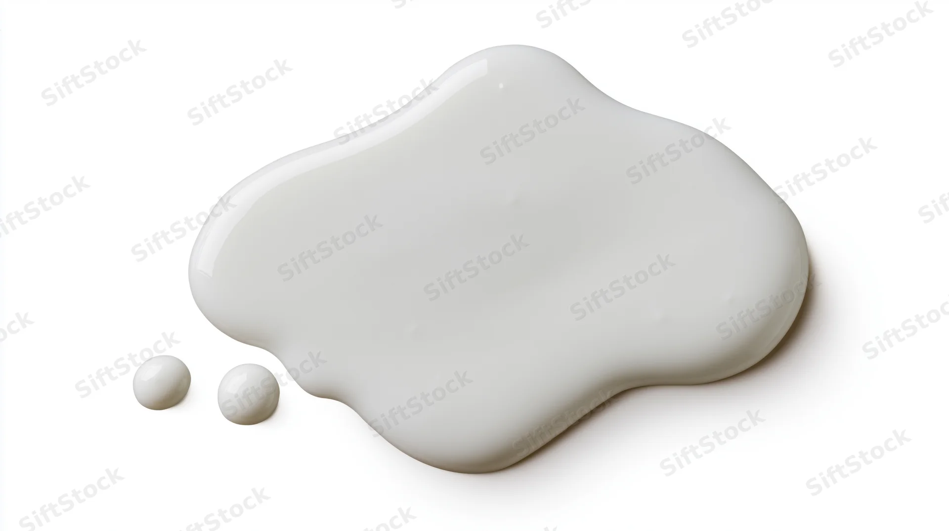 White milk or cream spill forming a smooth rounded puddle on a plain surface