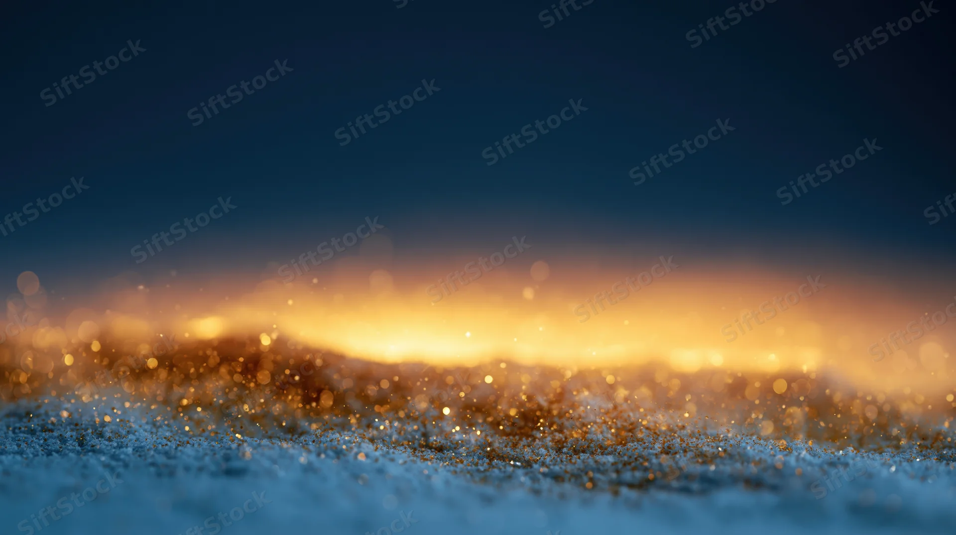 Abstract bokeh background with floating golden light particles on a dark blue surface