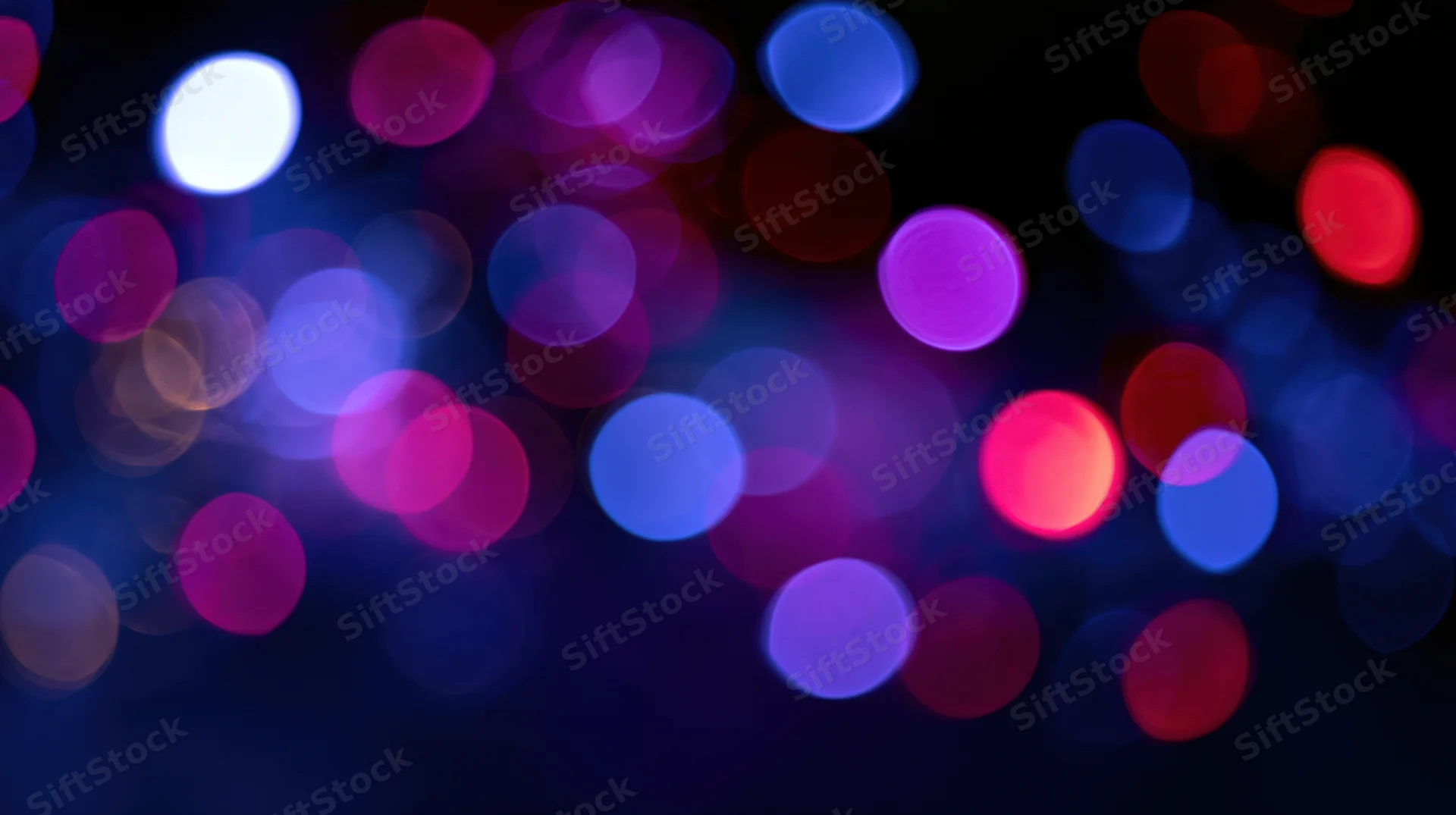 Abstract bokeh background with out-of-focus colored light orbs