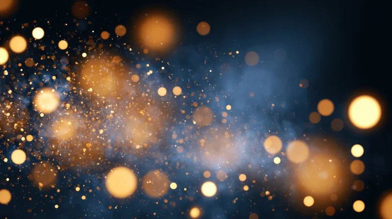 Abstract bokeh background with scattered gold and warm amber