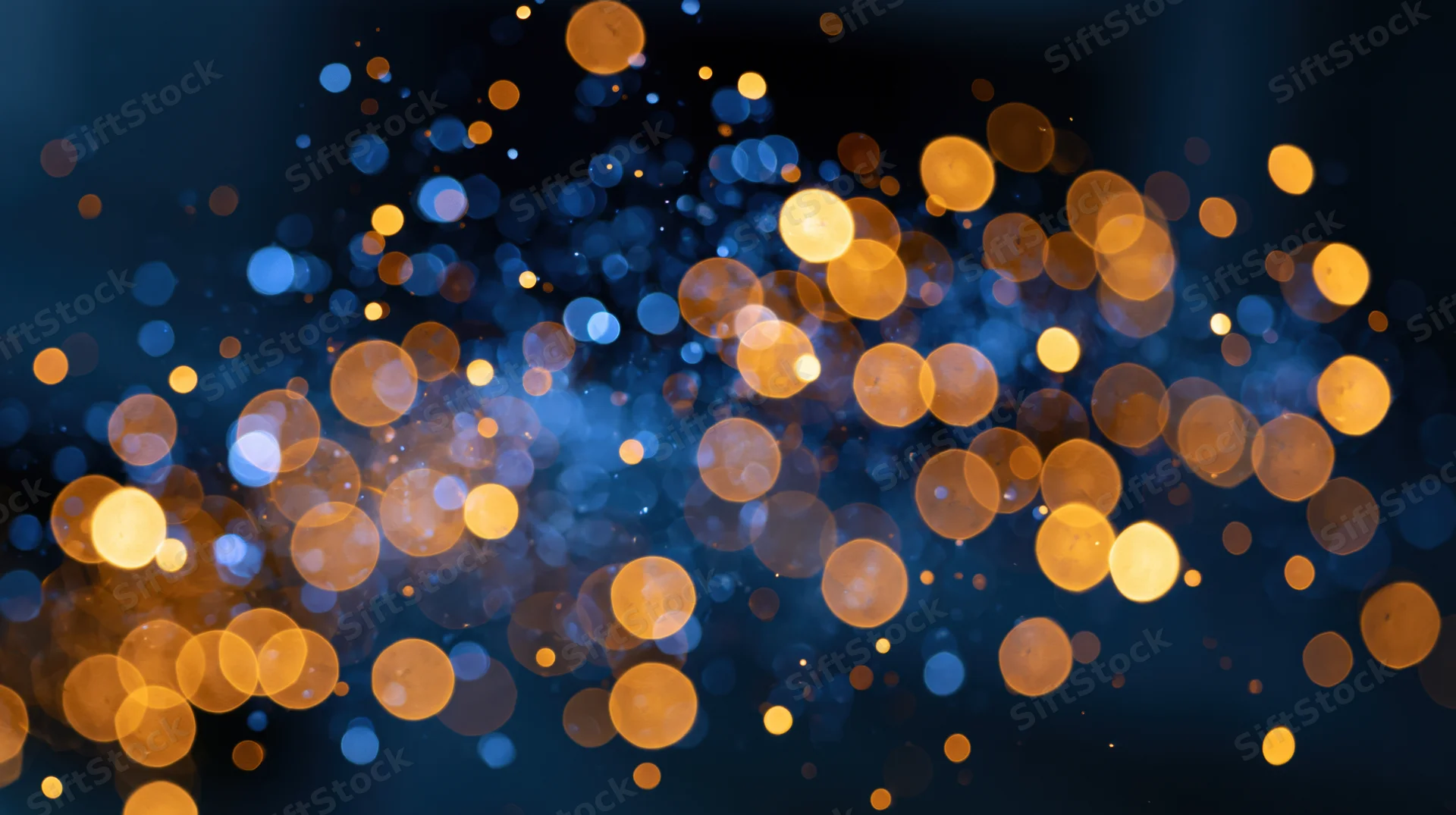 Abstract bokeh lights in blue and golden hues filling the frame