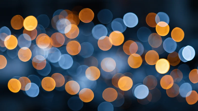 Abstract bokeh field of out-of-focus circular lights in warm and cool tones filling the frame