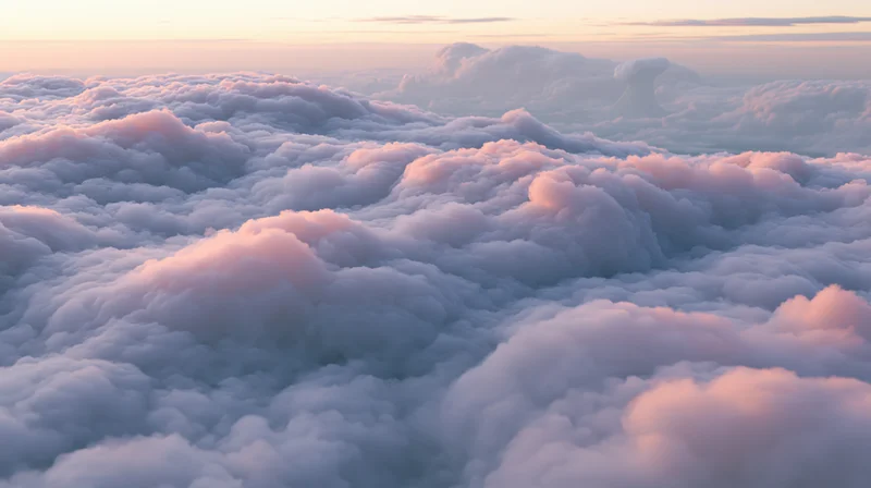 Aerial view of billowing cumulus clouds above the horizon at sunset