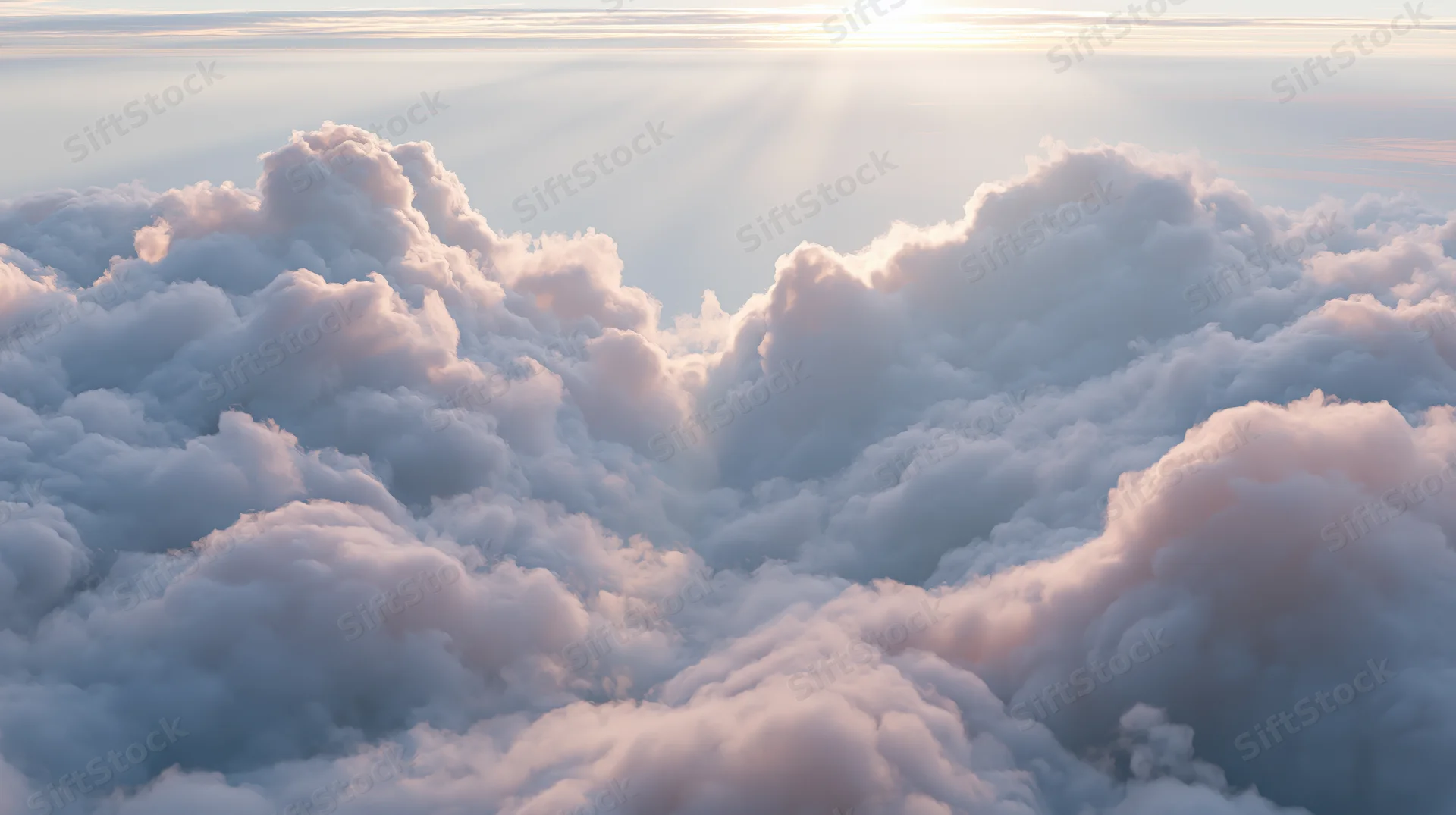 Aerial view of fluffy clouds above horizon at sunrise