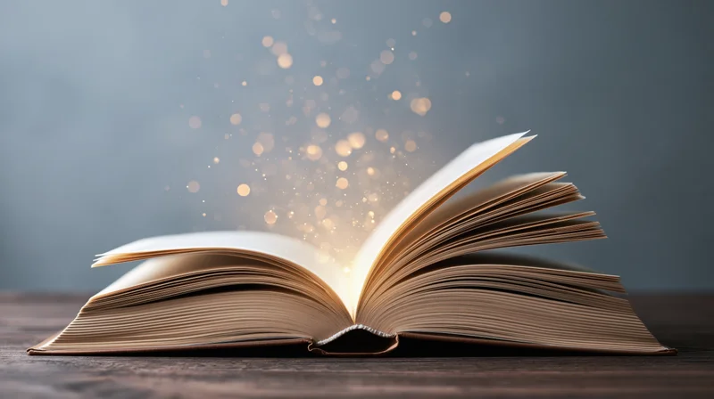 Open hardcover book on dark wooden table with glowing sparkles rising from pages