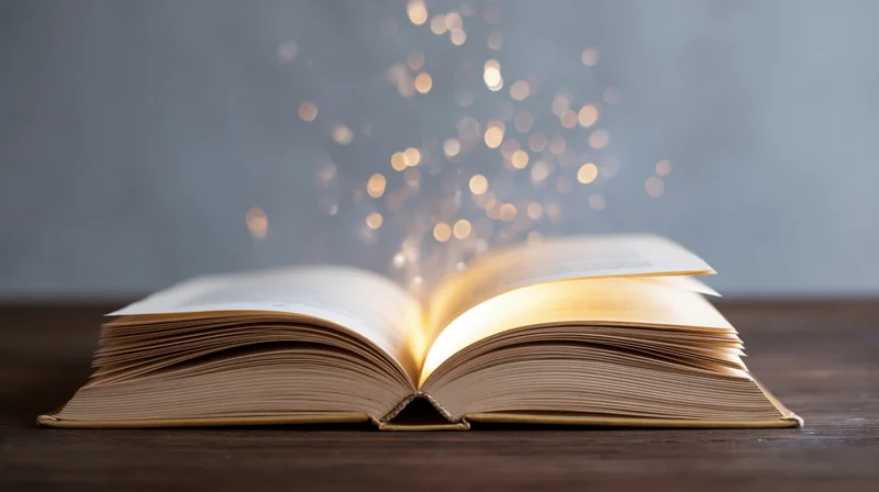Open hardcover book glowing with sparkles on dark wooden table