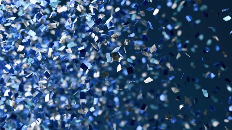 Blue and silver confetti pieces mid fall scattered around