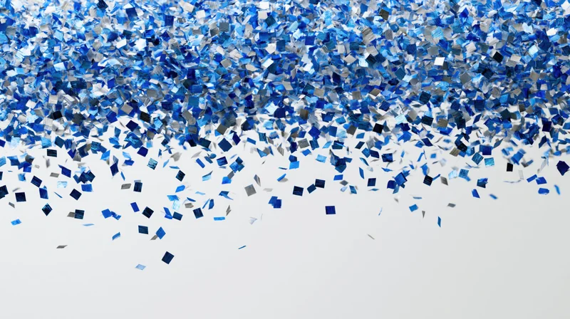 Blue metallic confetti pieces falling and scattering midair against white background