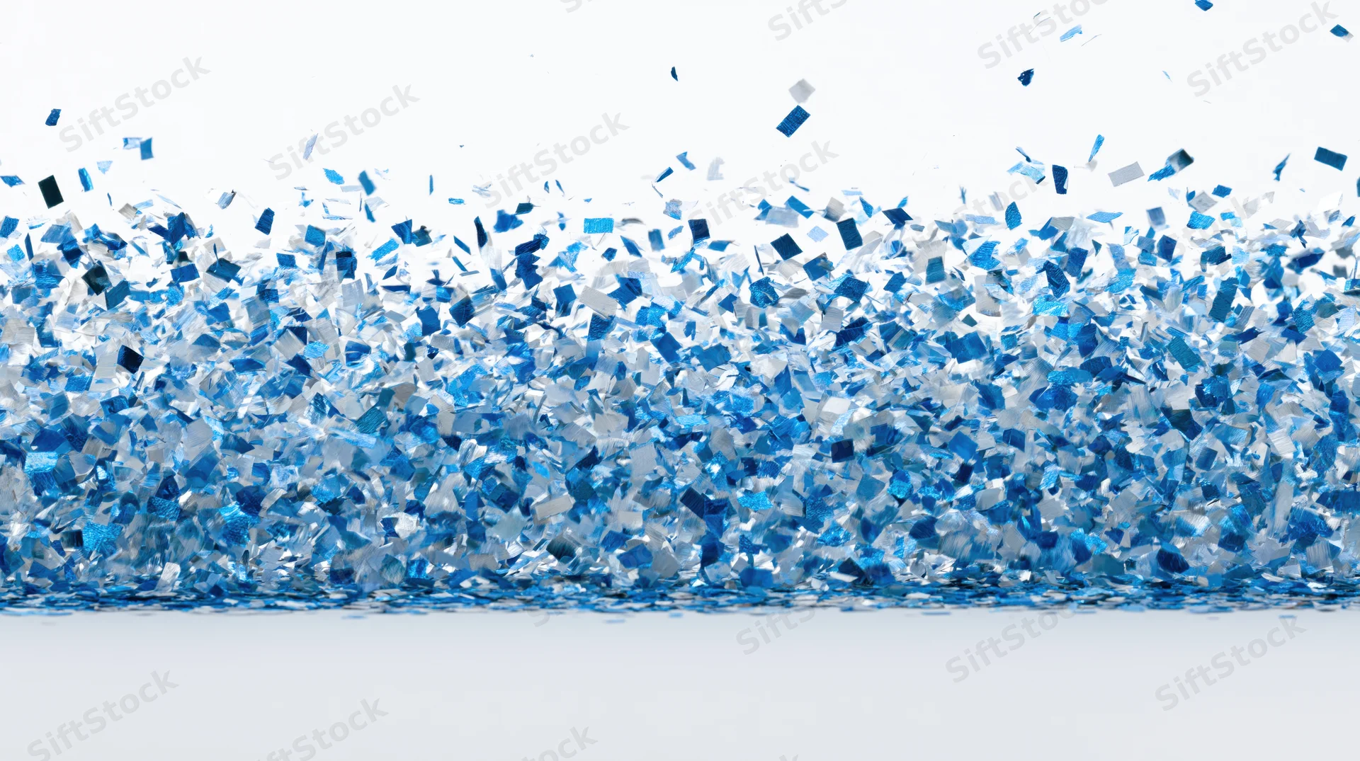 Blue metallic confetti pieces falling and scattering mid-air against white background