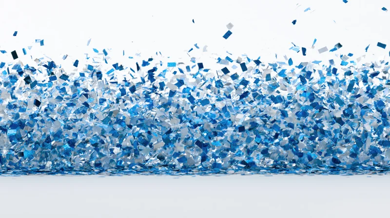Blue metallic confetti pieces falling and scattering mid-air against white background