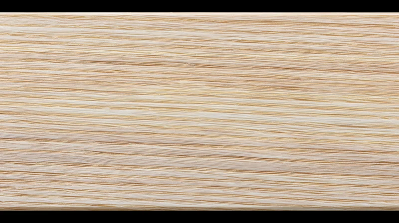 Close-up of pale ash wood surface showing fine horizontal grain pattern