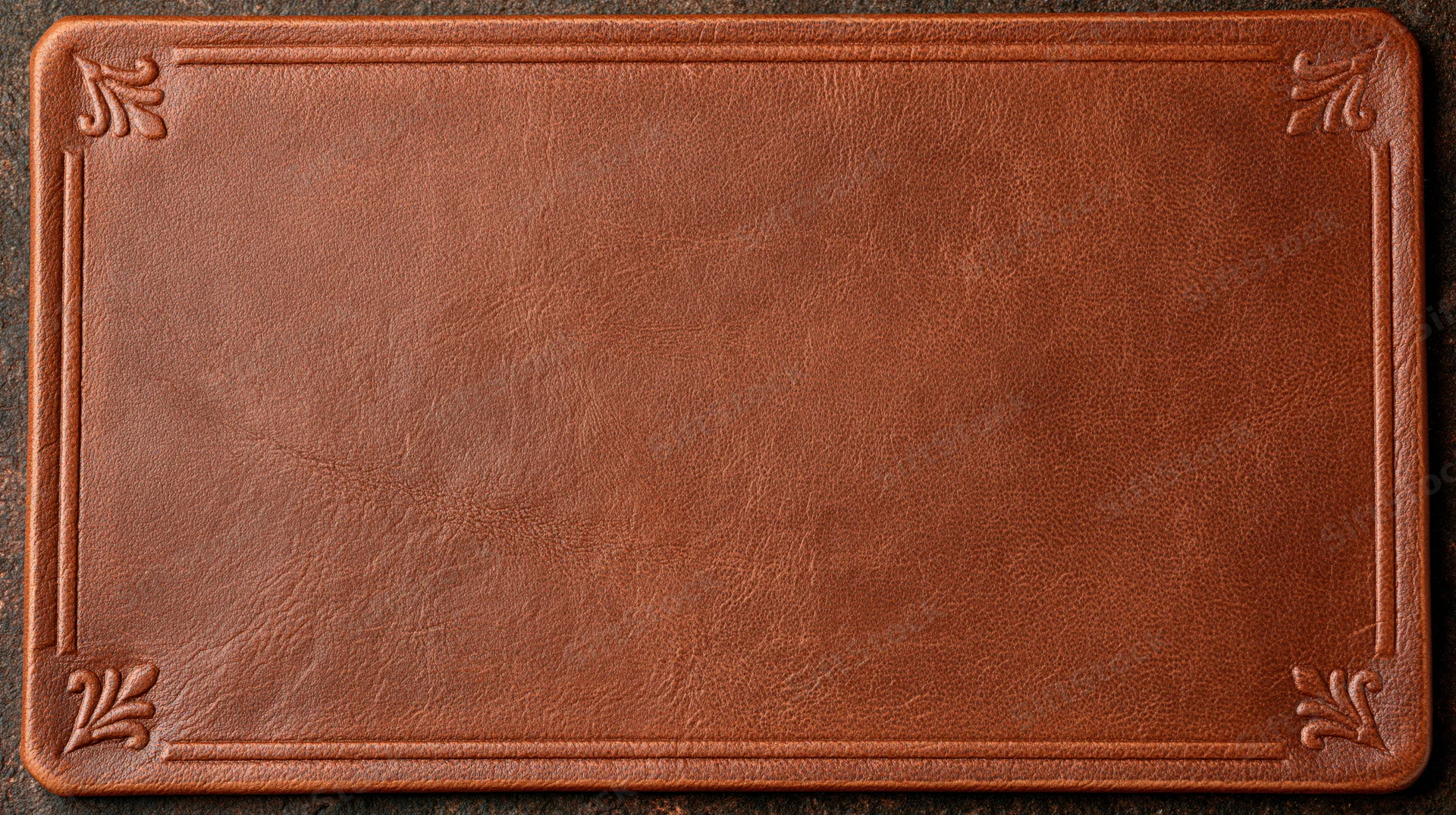 Aged brown leather surface with embossed decorative border in flat lay view