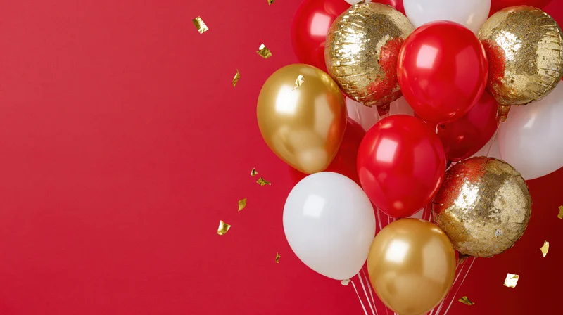 Cluster of red, gold, and white balloons with gold confetti on a red background