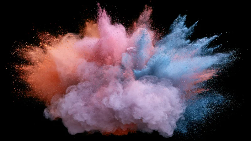 Colored powder exploding mid-burst against black background
