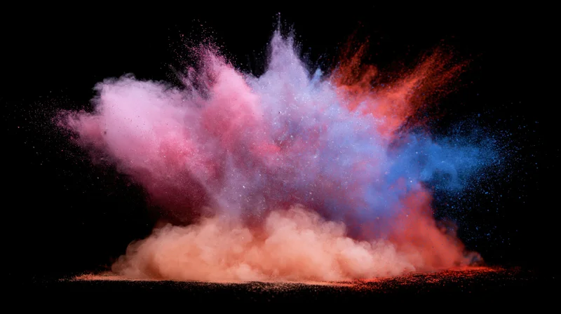 Colored powder exploding in mid-air against a black background
