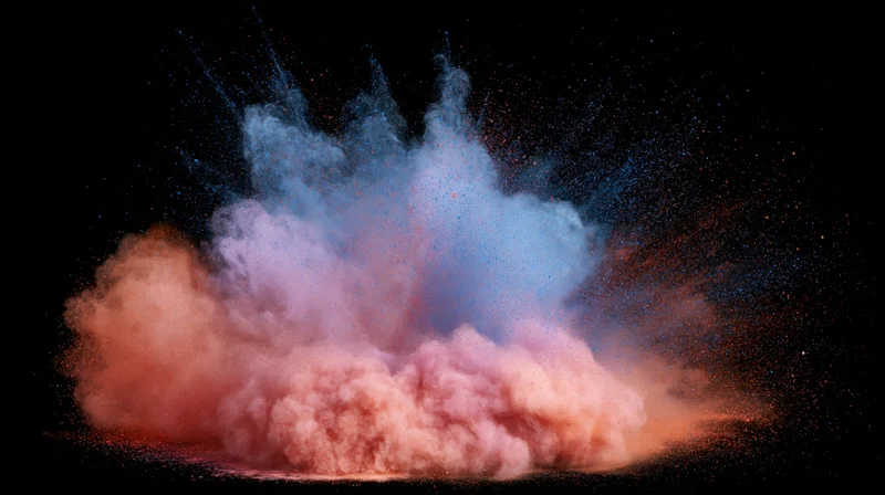 Colored powder exploding in mid-air against a black background