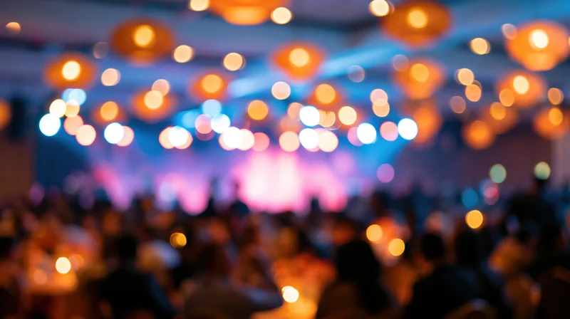 Blurred view of a crowd in a banquet hall with colorful bokeh lights overhead