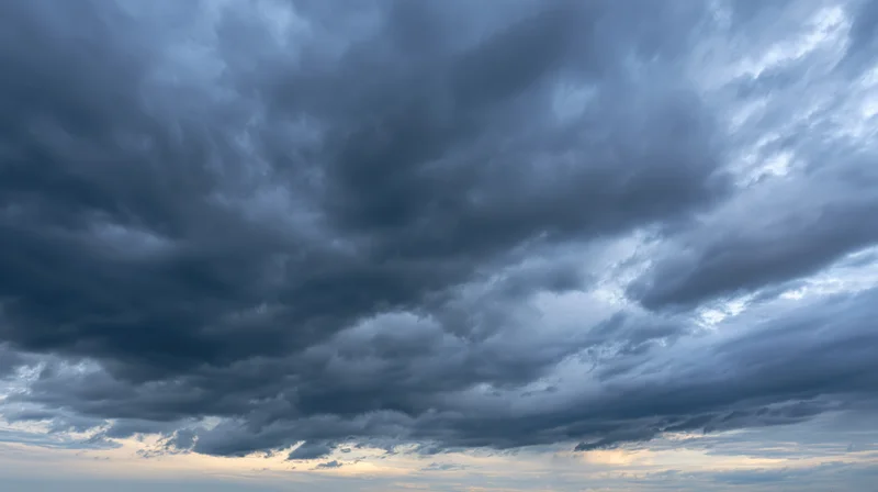 Dramatic stormy sky filled with dark cumulonimbus clouds at twilight