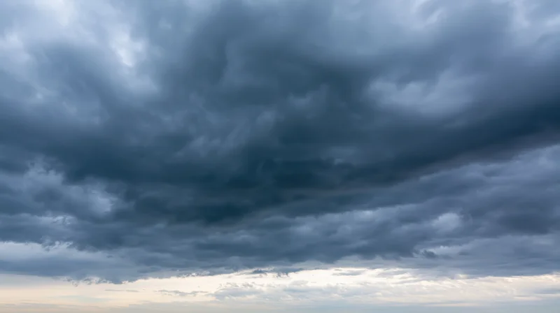 Dramatic stormy sky filled with dark cumulonimbus clouds at twilight