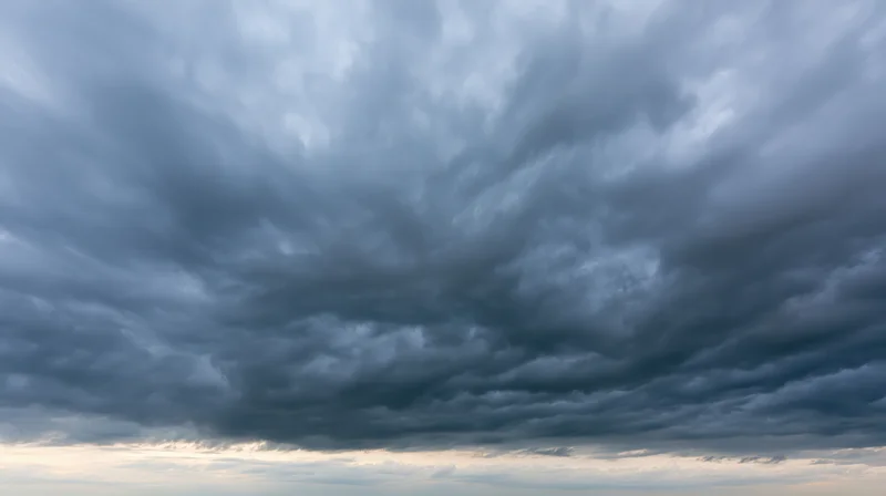 Dramatic stormy sky filled with dark cumulonimbus clouds at twilight