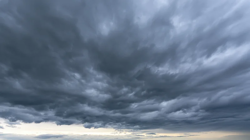 Dramatic stormy sky filled with dark cumulonimbus clouds at twilight