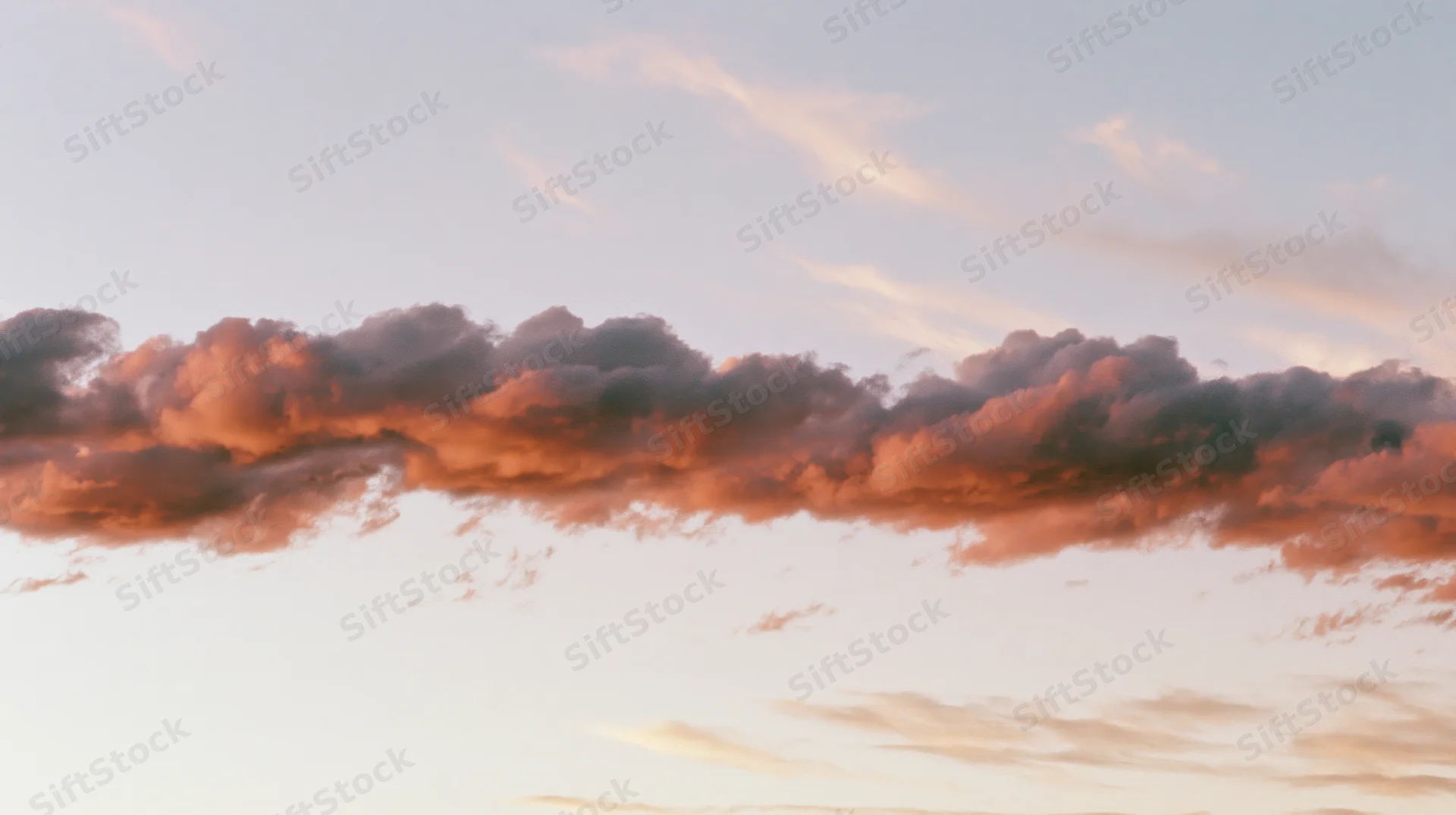 Dramatic cloud formation at sunset stretching across the sky