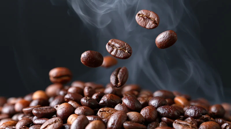 Freshly roasted coffee beans tumbling and floating above a pile