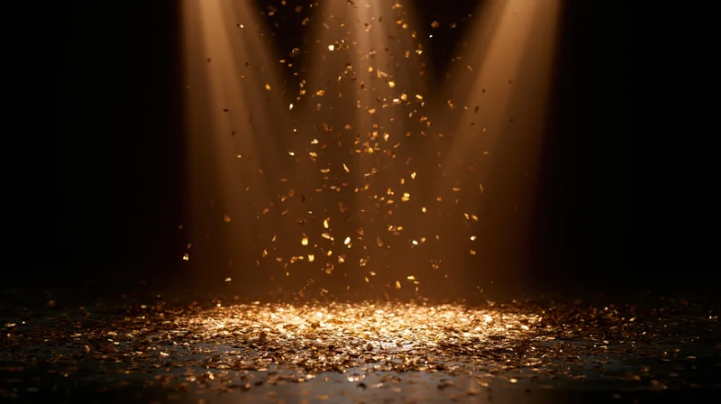 Gold metallic confetti falling through converging stage spotlights onto a dark floor