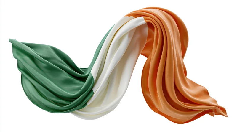 Flowing irish tricolor flag in silk fabric isolated on white background