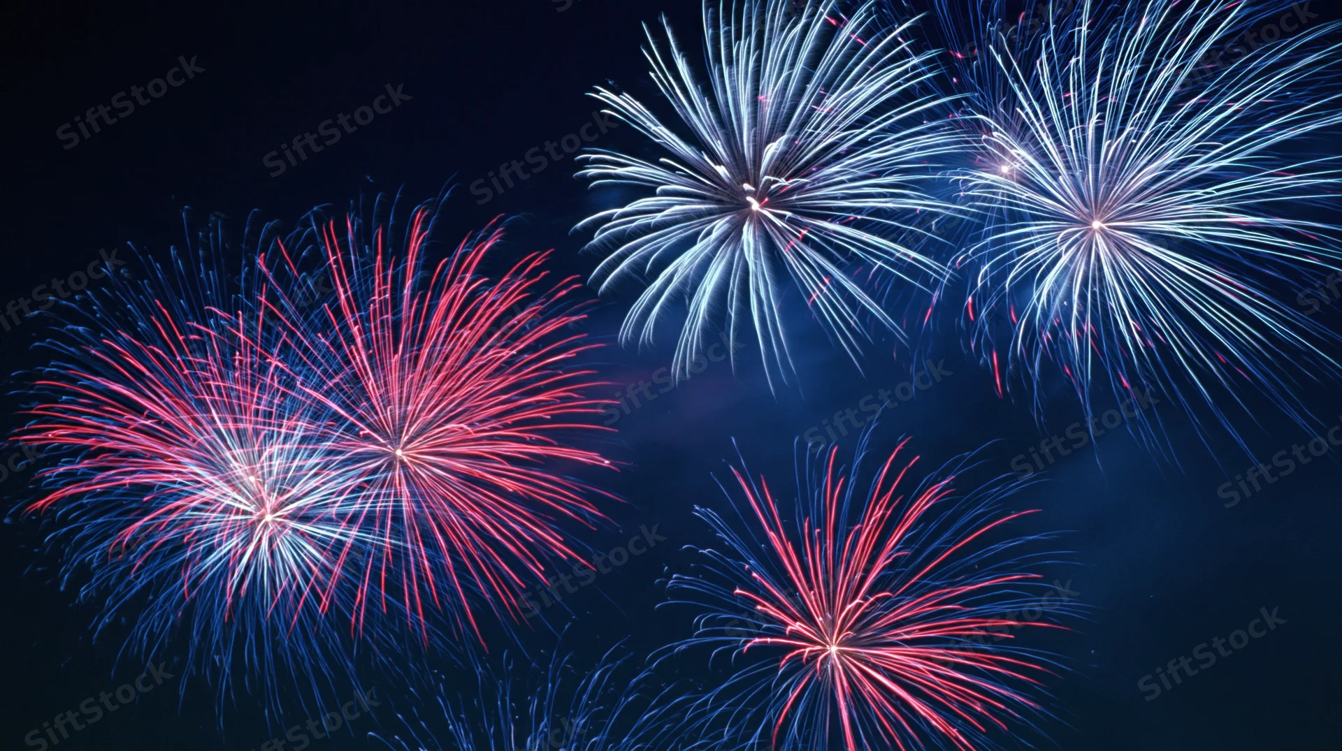 Fireworks bursting in the night sky during a celebration event