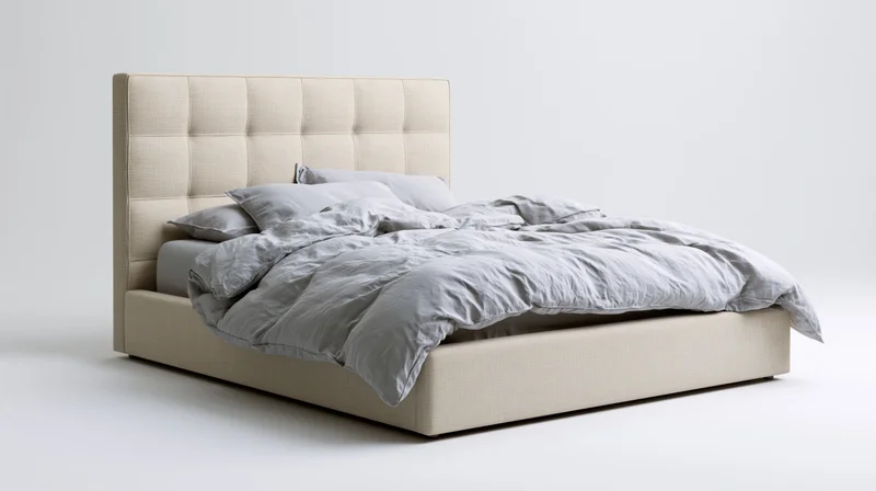 Queen-size upholstered bed with tufted linen headboard and gray bedding on white background