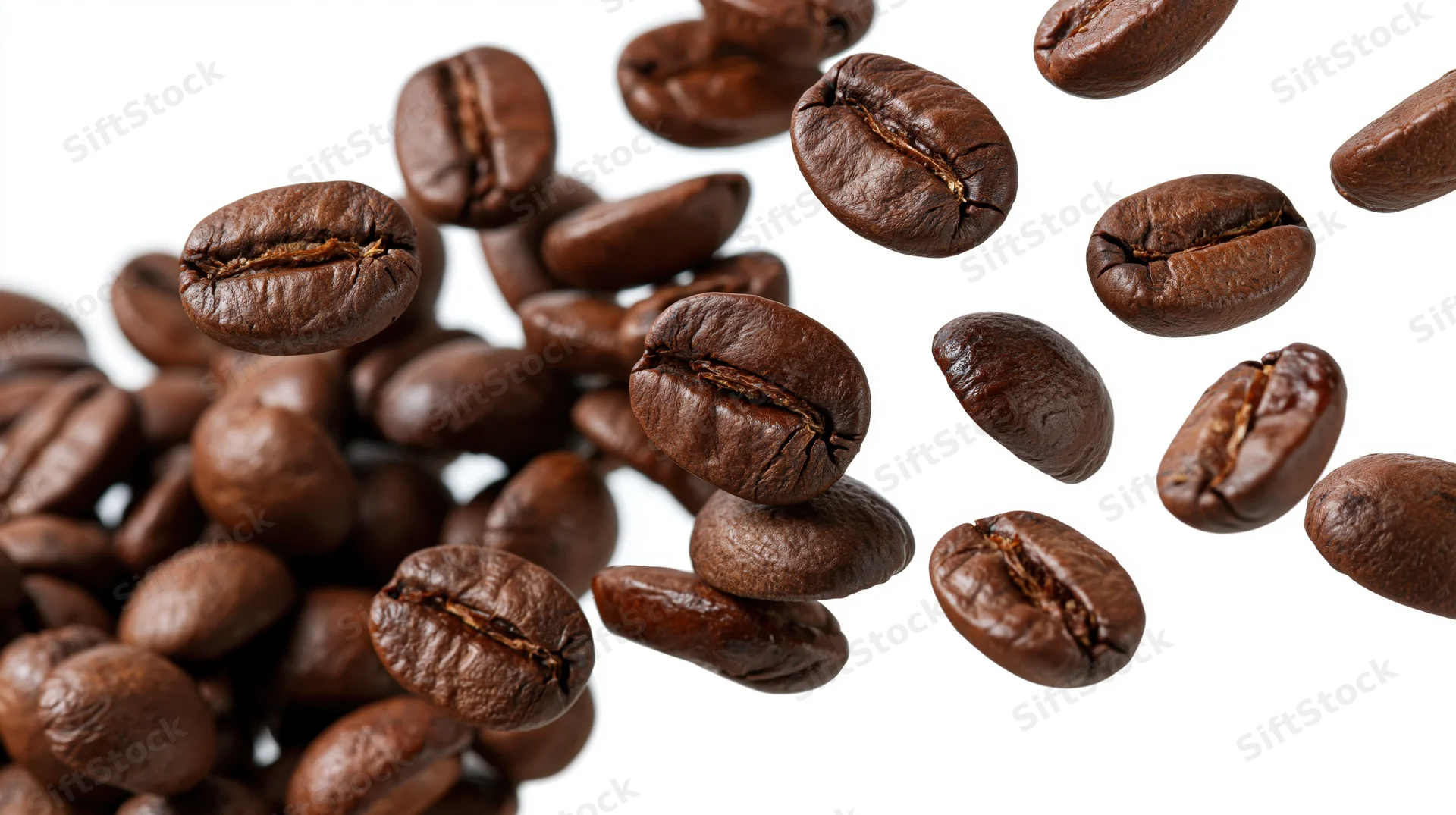Roasted coffee beans falling midair against white background