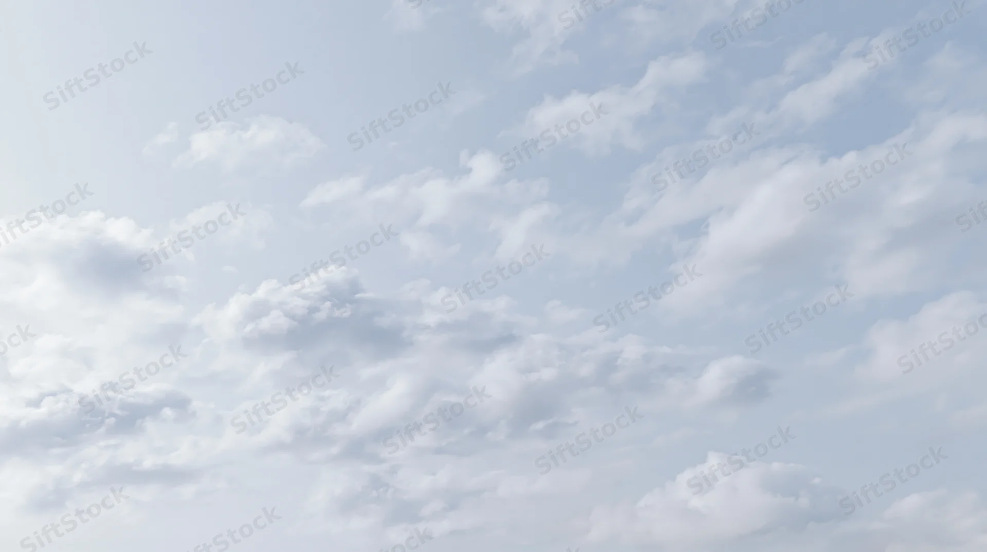 Scattered cumulus clouds drifting across a wide open sky