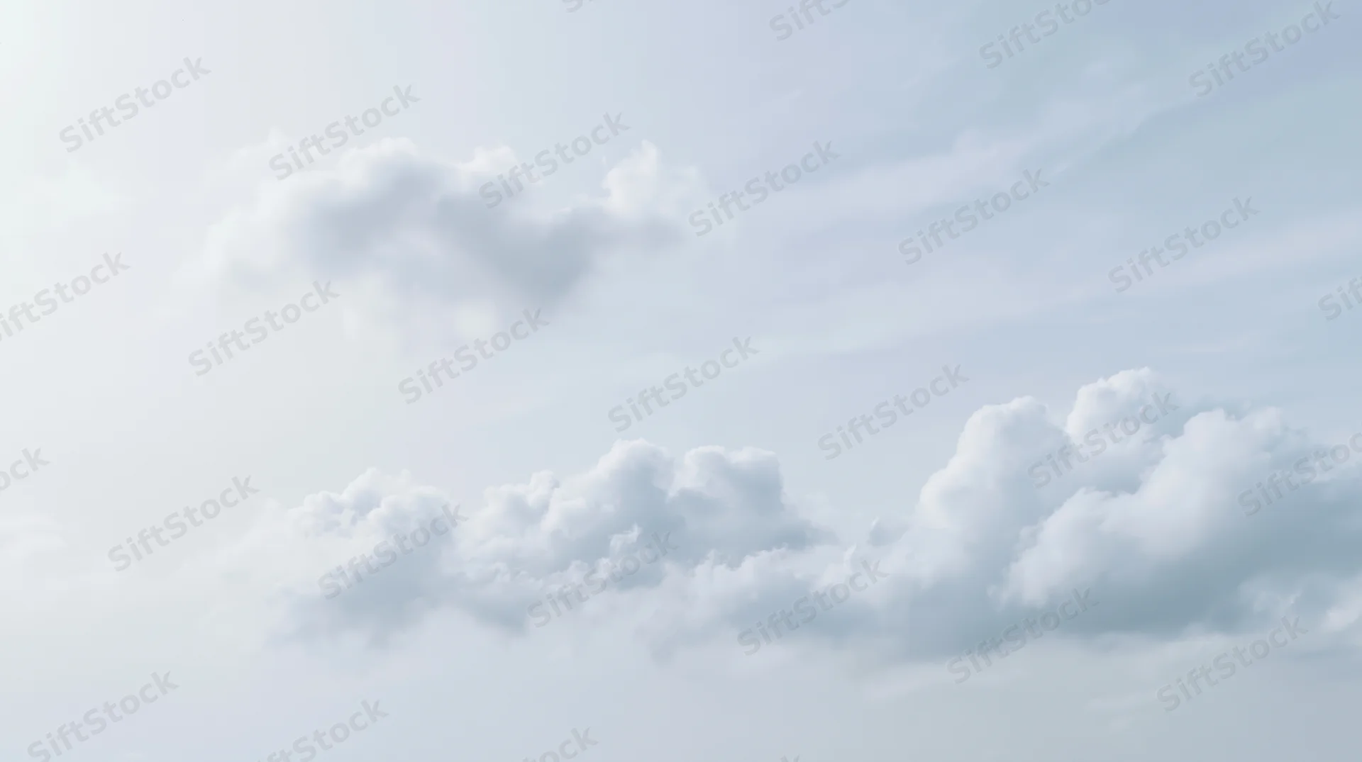 Scattered cumulus clouds drifting across a wide open sky