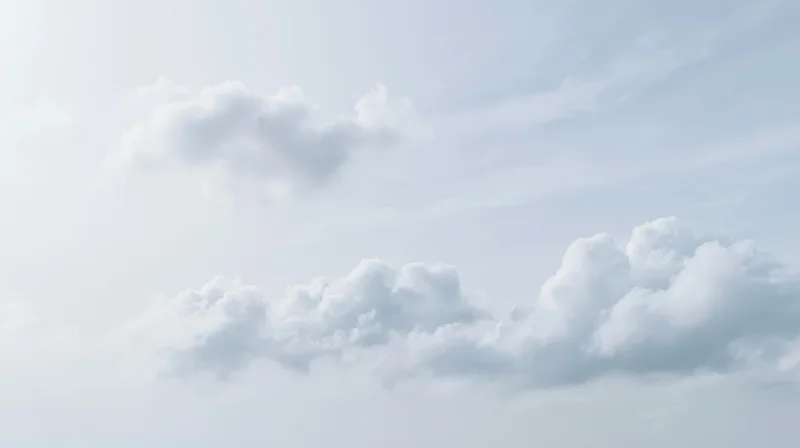 Scattered cumulus clouds drifting across a wide open sky