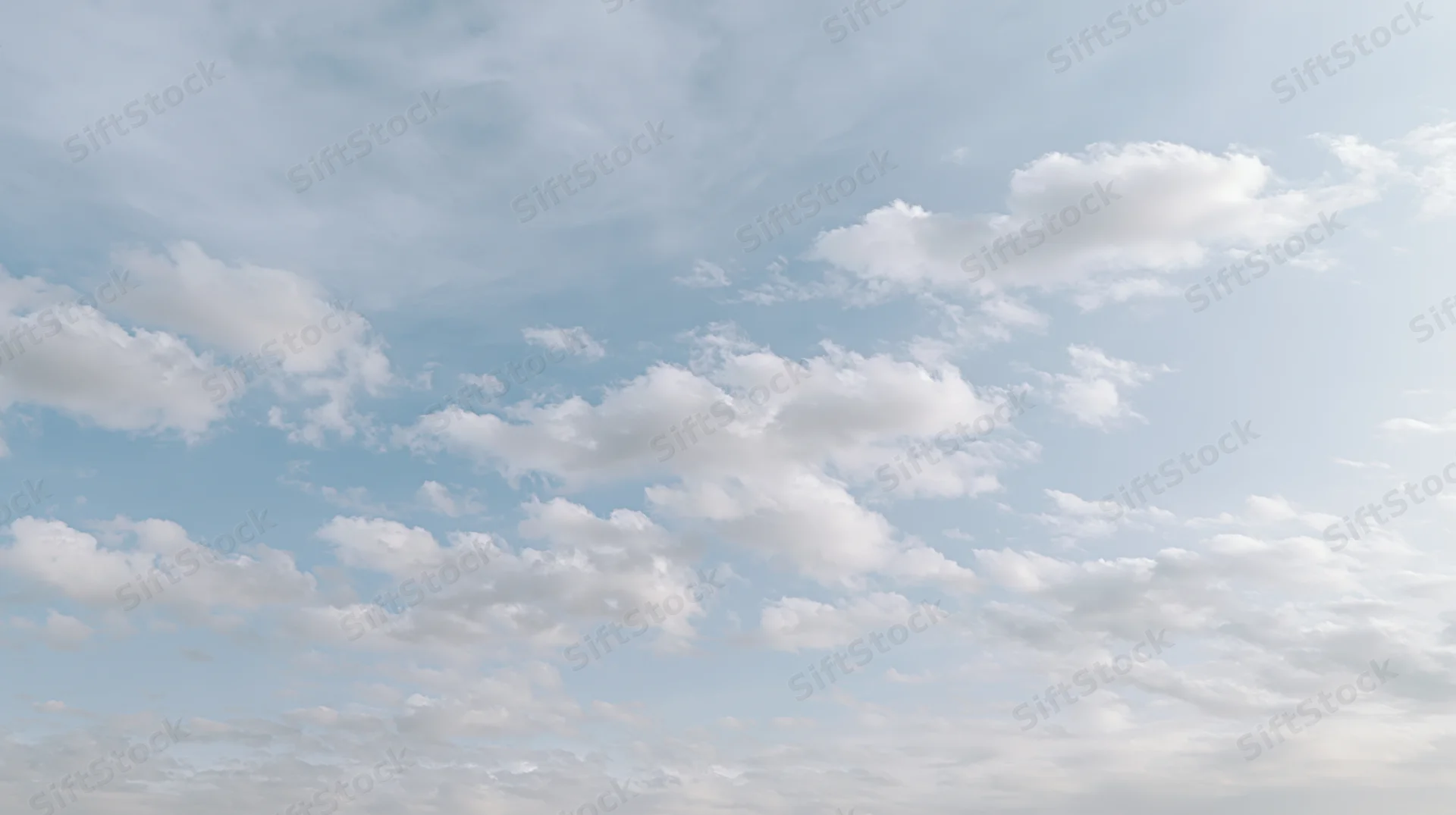 Scattered cumulus clouds drifting across a wide open sky