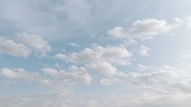 Scattered cumulus clouds drifting across a wide open sky